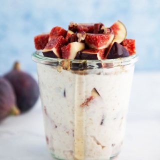 A jar of overnight oats topped with figs and bits of pecans