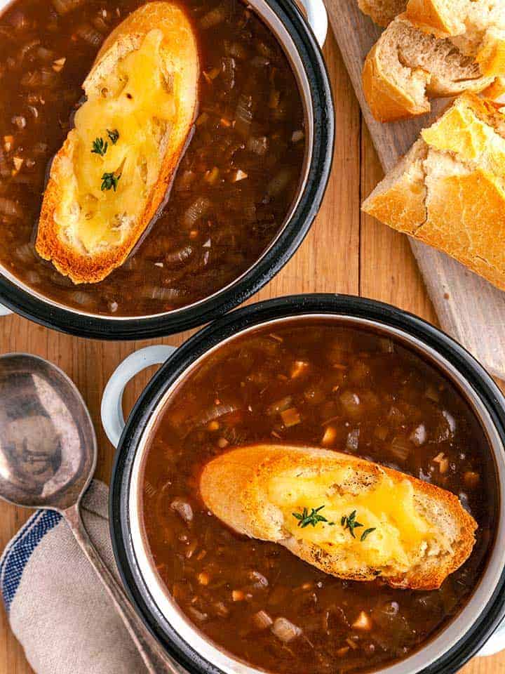 Two bowls of French Onion soup with cheesy croutons