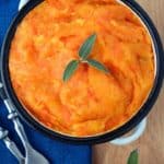 A dish of swede and carrot mash on a blue napkin