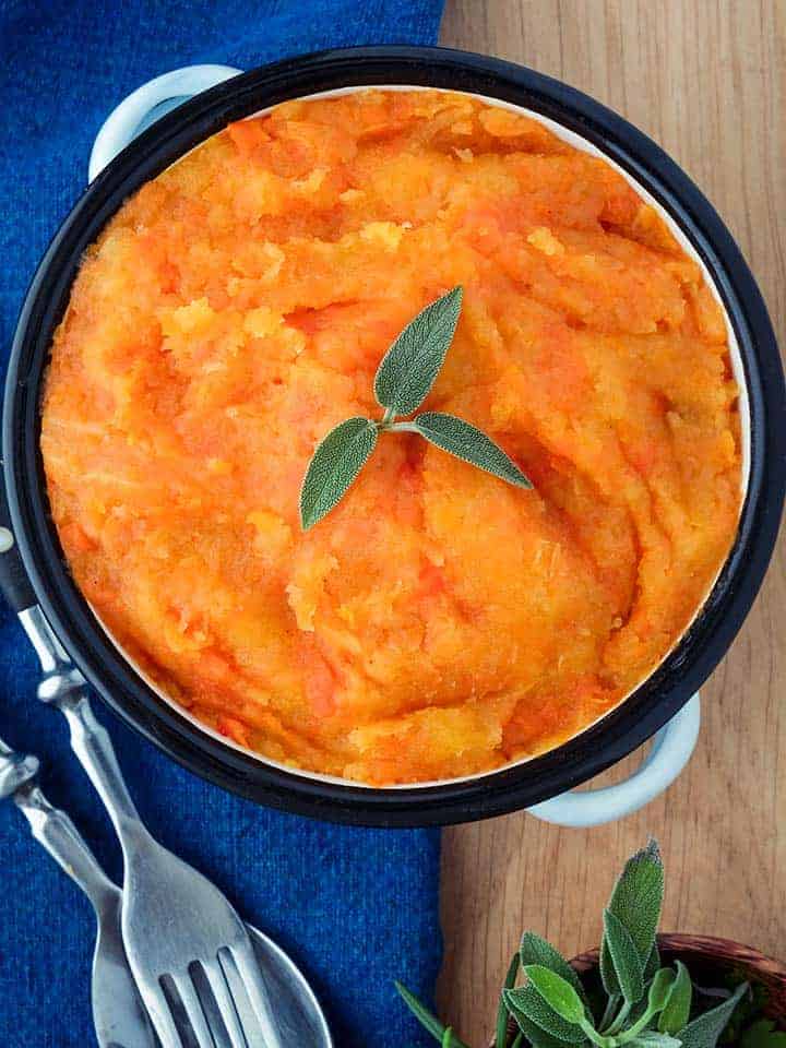 A dish of swede and carrot mash on a blue napkin