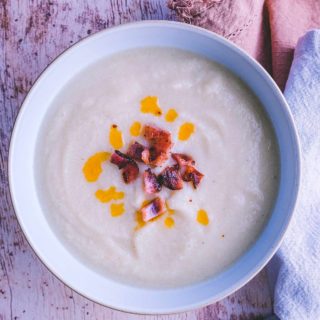 A white bowl full of white bean soup