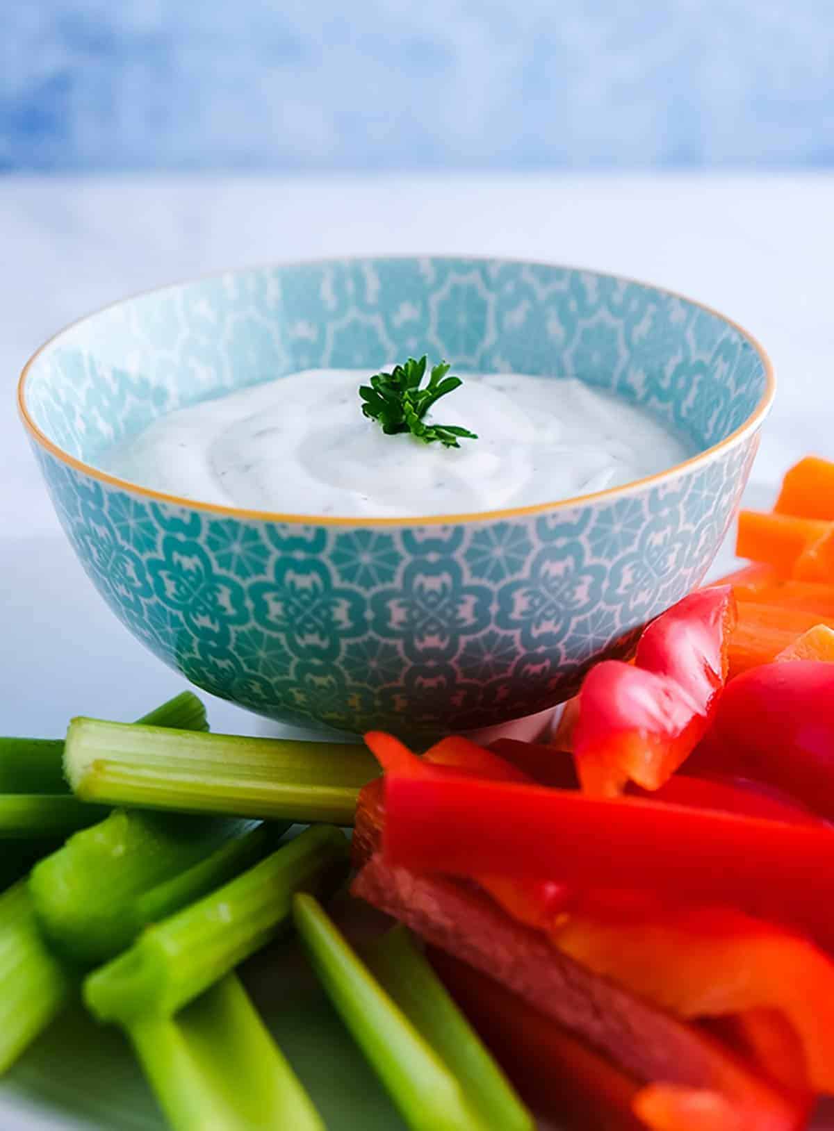 A bowl of ranch dip with crudites