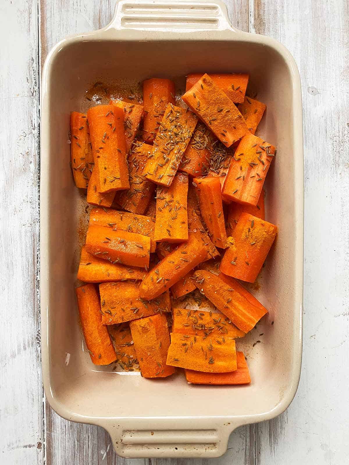 A dish of chopped carrots with cumin seeds