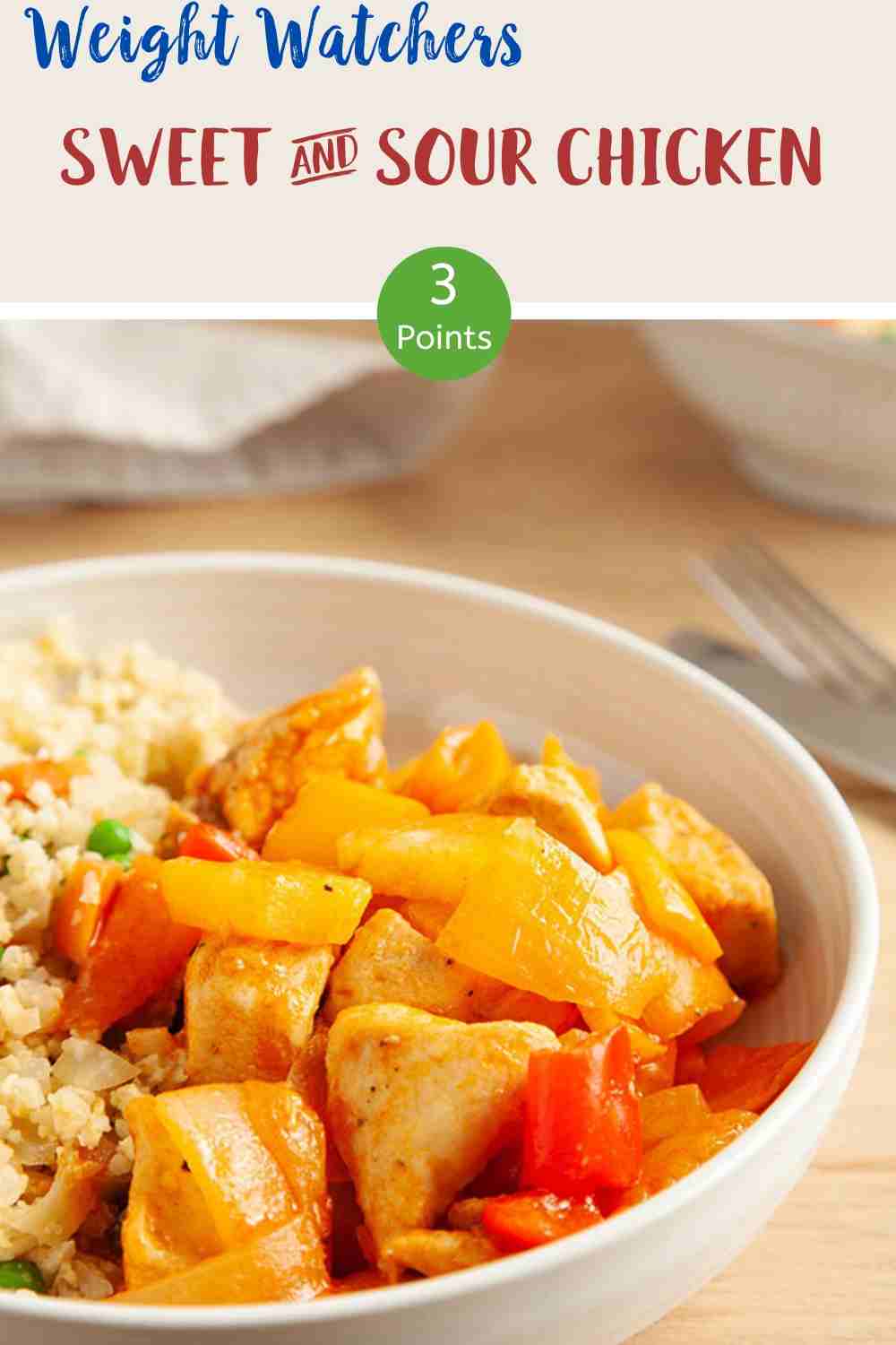 A white bowl of sweet & sour chicken with cauliflower rice on a wooden table