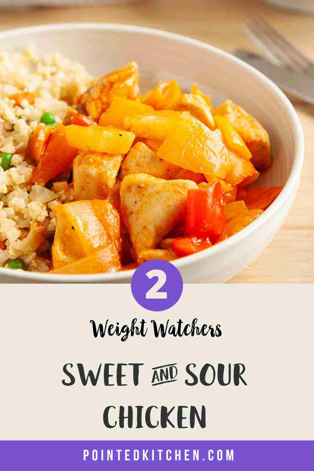 A white bowl of sweet & sour chicken with cauliflower rice on a wooden table