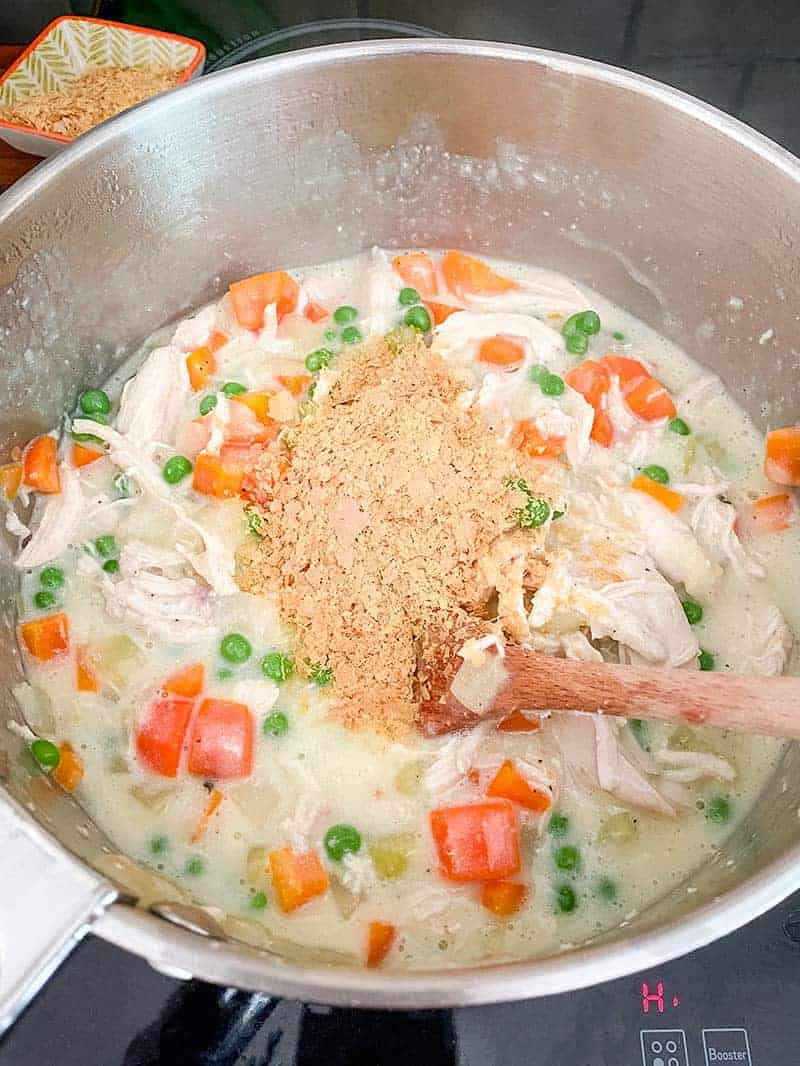 A sauce pan full of chicken pot pie filling mixture