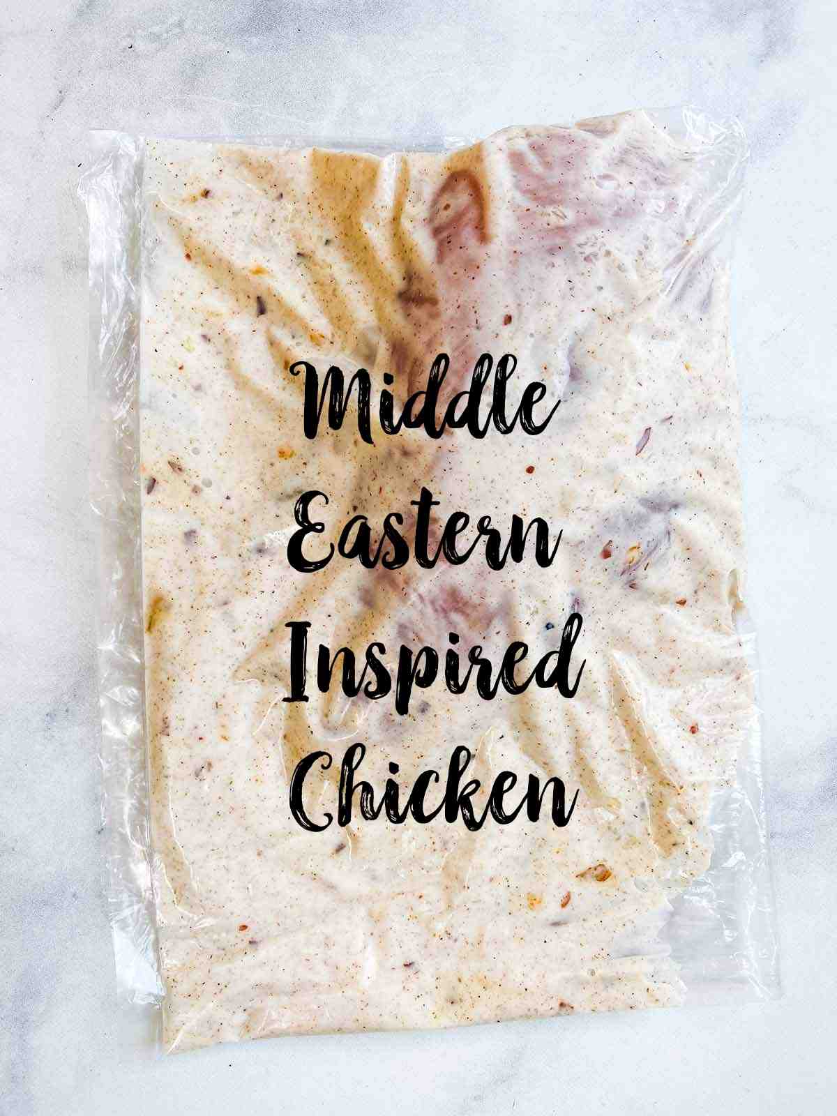 A plastic bag with a chicken breast and marinade with text overlay