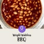 A white ceramic bowl of baked beans with text overlay stating 'Weight Watchers BBQ Baked Beans'.
