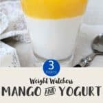 A glass of a layed dessert of mango and yogurt parfait topped with pomegranate seeds with text overlay stating 'Weight Watchers Mango & Yogurt Parfait'.