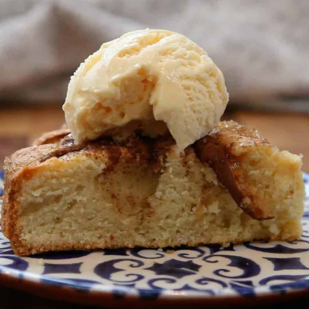 A slice of apple cake with ice cream