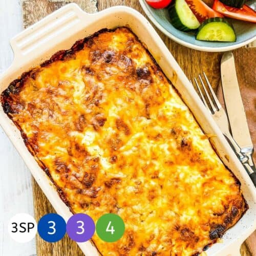 A baked casserole on a wooden board with graphics of the WW Smartpoint values.