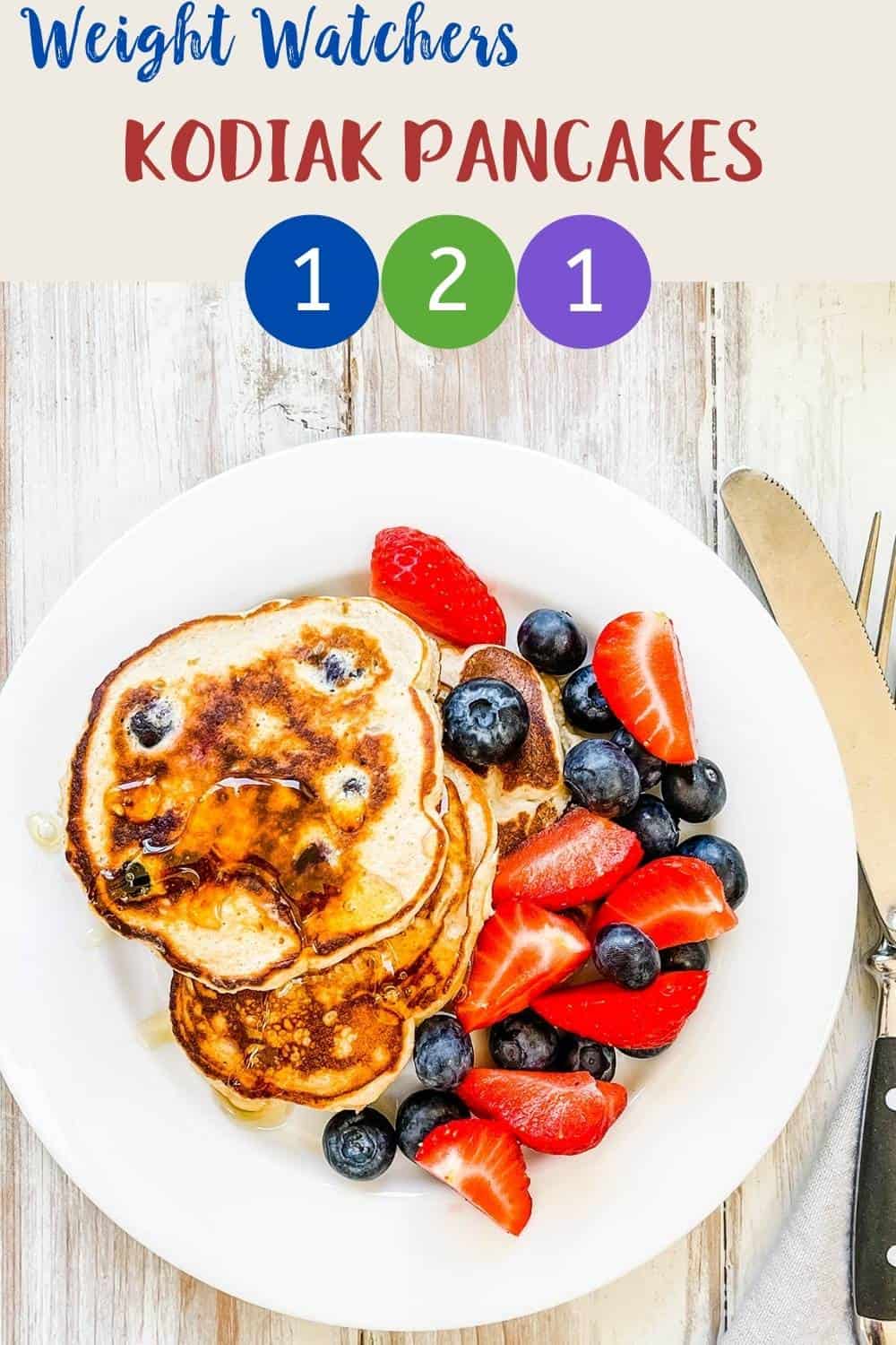 A plate of pancakes with mixed berries with text overlay 'Weight Watchers Kodiak Pancakes'.