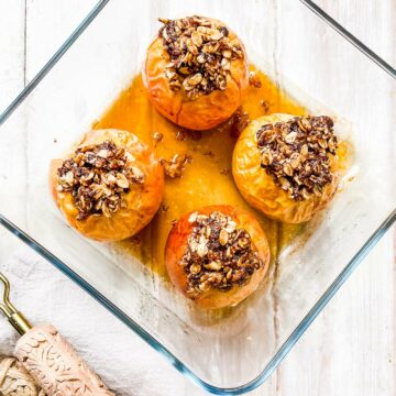 A glass dish with 4 baked apples.