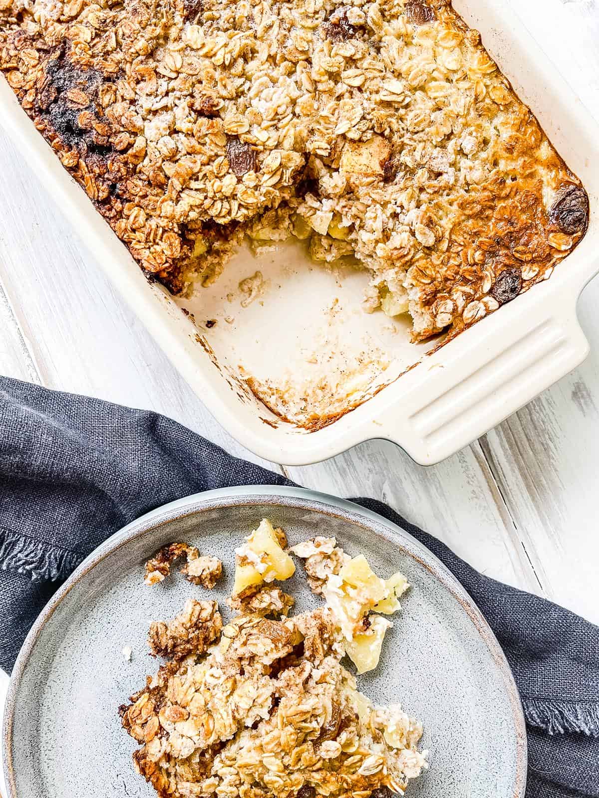 A dish of Weight Watchers Baked Oatmeal with apples on a white table.