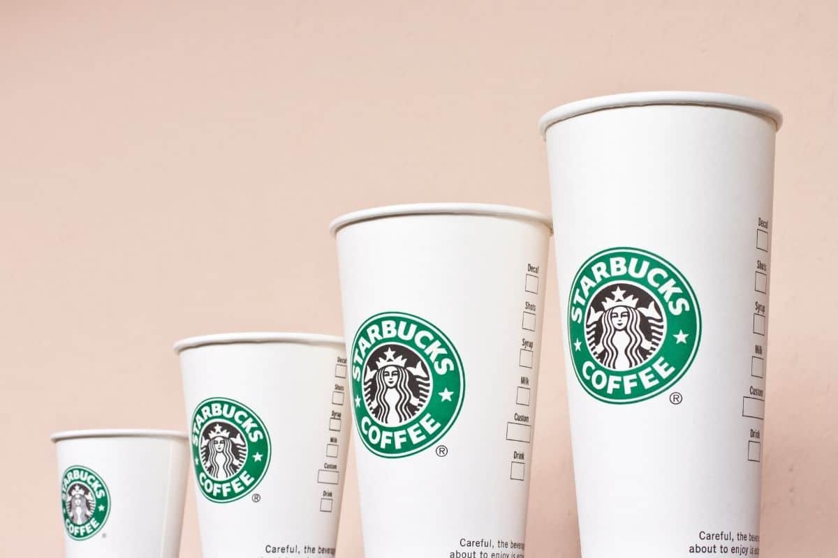 Four sizes of starbucks cups lined up.