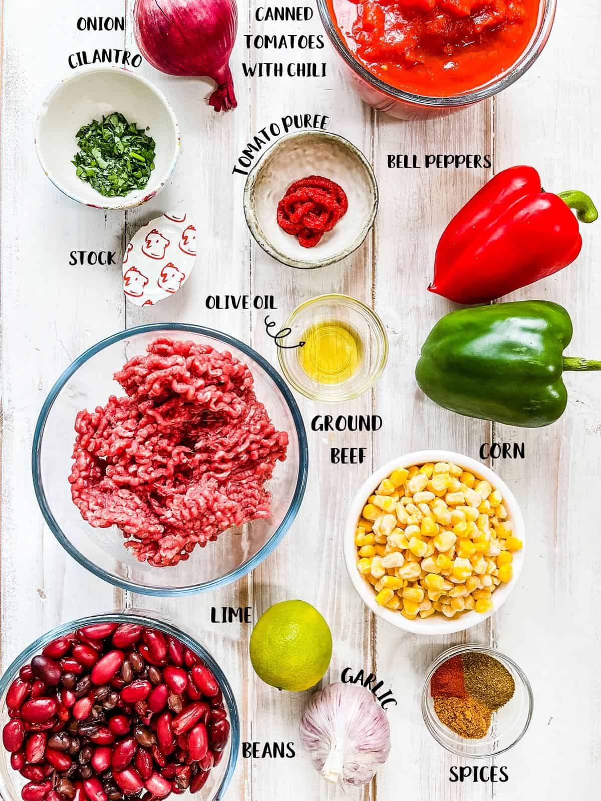 The ingredients to make WW taco soup laid out on a wooden table - with labels.