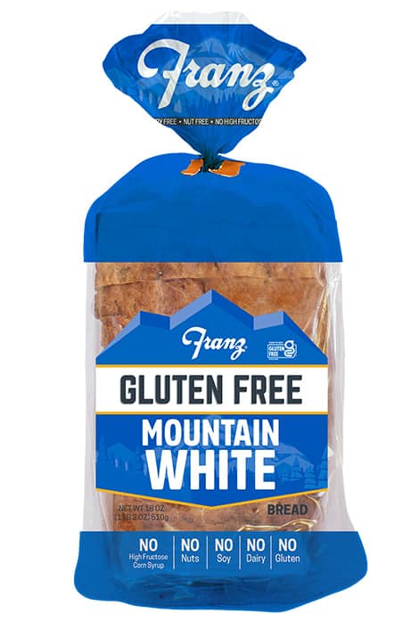 A packet of Franz Gluten Free Mountain White Bread in blue packaging.