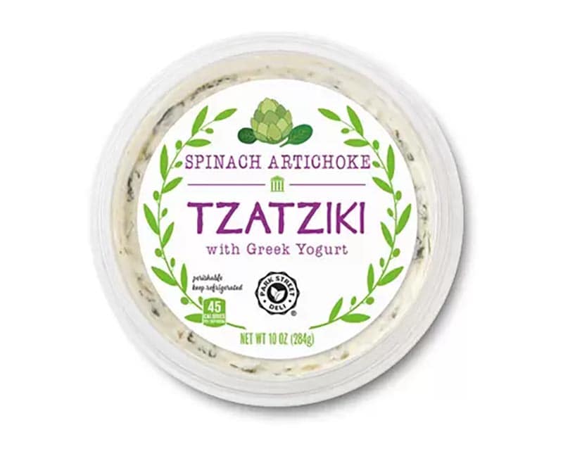 A pot of spinach artichoke Tzatziki on a white background.